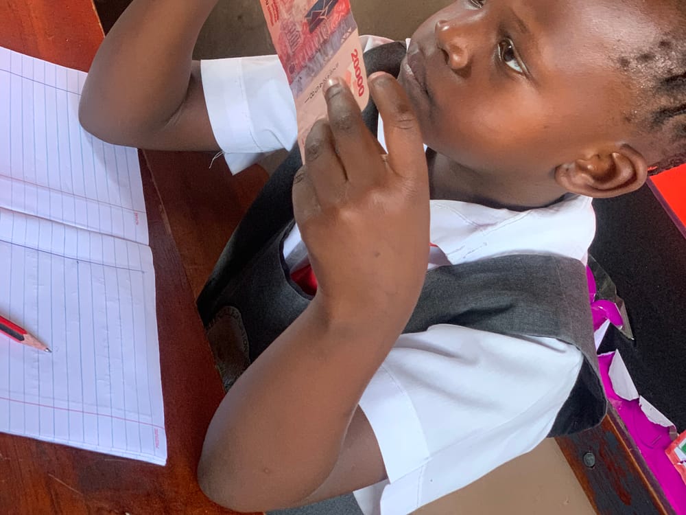 A primary pupil at her desk during a money and counting lesson